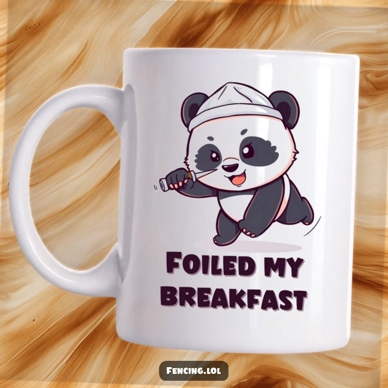 Funny mug showing a small, determined panda wearing a tiny foil hat lunging forward with a foil, depicting heroic and comical effort.