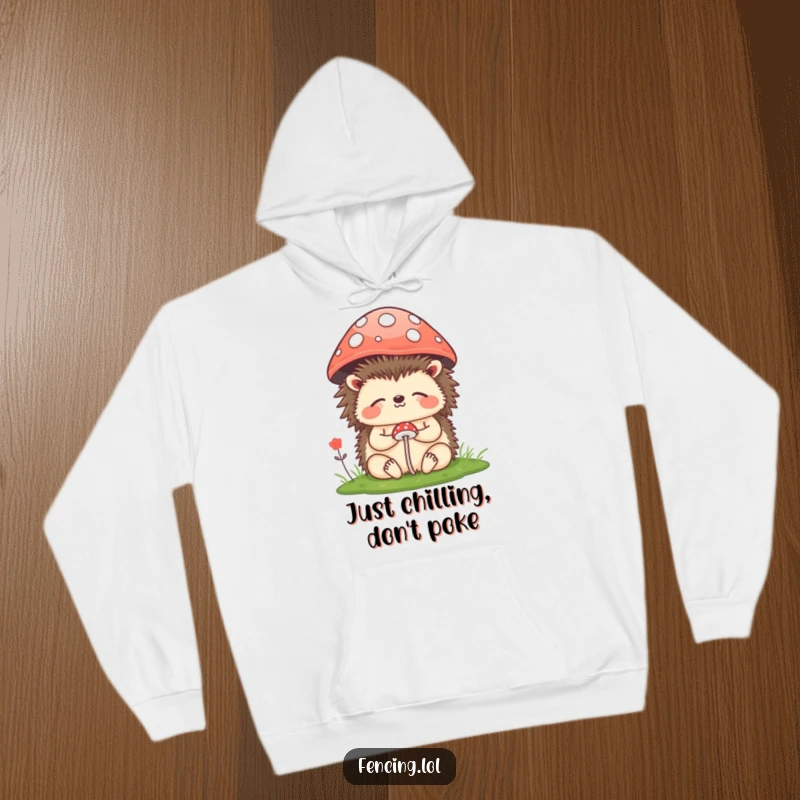 Funny Hoodie: A content hedgehog meditating peacefully under a tiny mushroom, offering warmth and a dose of humorous relaxation vibes.